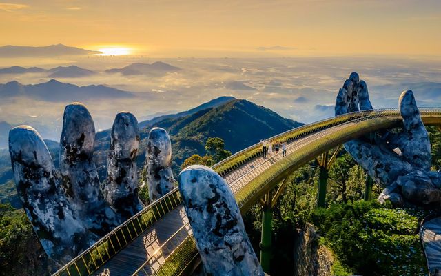The Golden Bridge held up by two giant stone hands