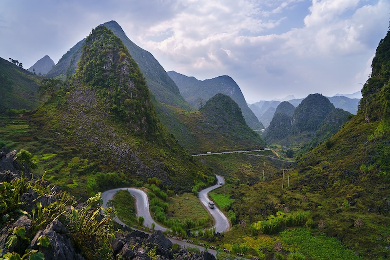 The winding roads of the Ha Giang Loop through lush mountains