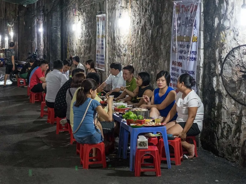 Locals enjoying street food in Hanoi