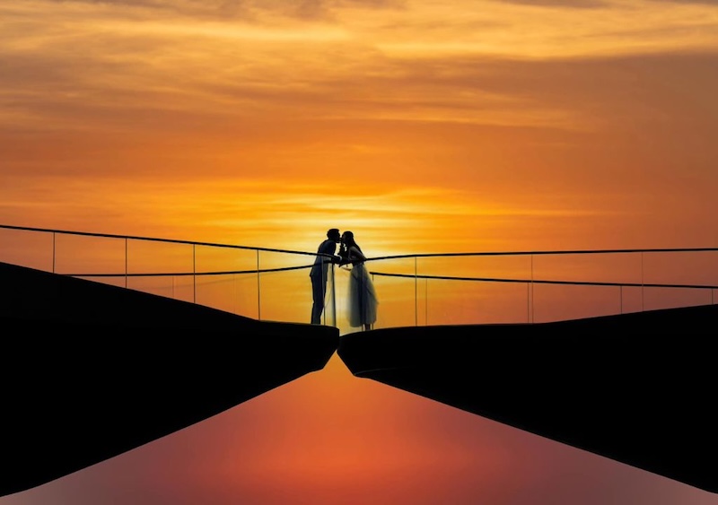 A couple enjoying a sunset on a bridge in Phu Quoc