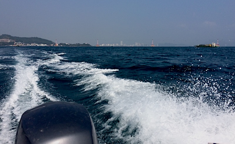 A tour boat cruising between the islands of Nha Trang Bay